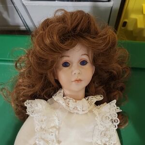 Porcelain Collectible Doll with Curly Auburn Hair and Blue Eyes In Great Shape